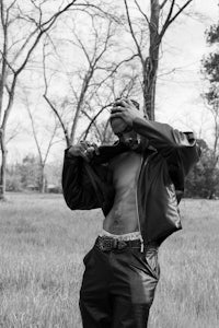 a black and white photo of a man standing in a field