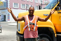 a man standing in front of a yellow truck