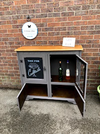 a wooden cabinet with a chalkboard on it
