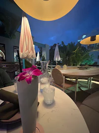 a white table with a vase of flowers on it