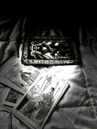 tarot cards on a bed in the dark