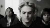 a black and white photo of a man with blonde hair
