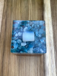 a blue and white stone box on a wooden table