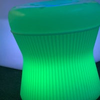 a green led stool sitting on a table