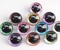 a group of colorful glittered eyes on a white surface