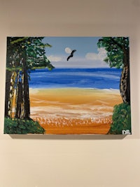 a painting of an eagle flying over a beach