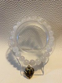 a clear ring with a heart shaped bead on it