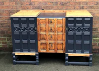 a black and wood sideboard with drawers