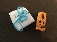 a small teddy bear with a string attached to it