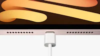 an apple macbook pro is connected to a charging cable