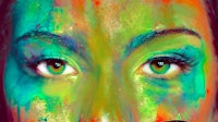 a woman's face with colorful paint on it