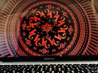 a black laptop with a red pattern on it
