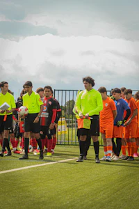a group of soccer players standing on a field