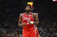 the philadelphia 76ers player is running on the court