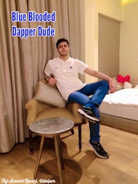 a man sitting on a chair with the words blue blooded dapper dude