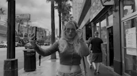 a black and white photo of a woman taking a selfie