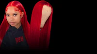 a woman with red hair is standing next to a black background