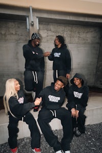 a group of people posing for a photo in a black hoodie