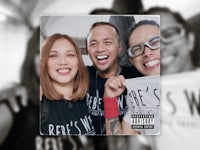 a group of people posing for a photo with a t - shirt