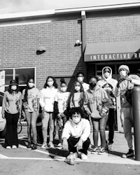 a group of people standing in front of a store
