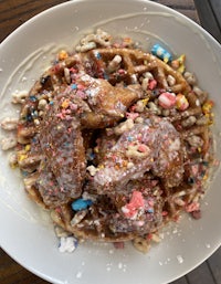 a plate with waffles and sprinkles on it