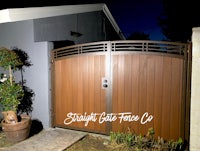 a wooden gate in front of a house at night