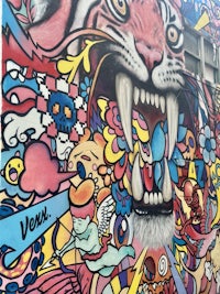 a colorful mural of a tiger on a building