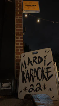 a sign that says mardi karaoke