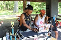 a group of people standing around a dj booth