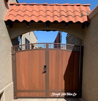 a wooden gate with a brown tile roof