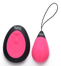 a pink and black vibrating toy next to a black cord