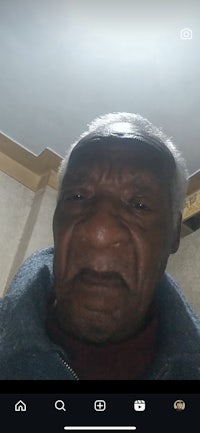 an old man is taking a selfie on his phone