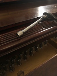 an old piano with a hammer on it