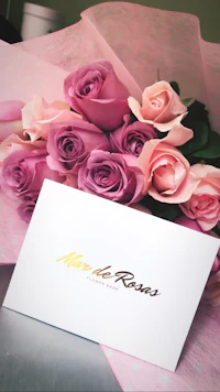 a card with pink and purple roses on it