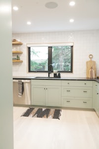 a kitchen with green cabinets