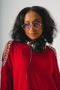 a young black woman wearing a plaid shirt