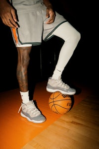 a basketball player posing with a ball in his hands