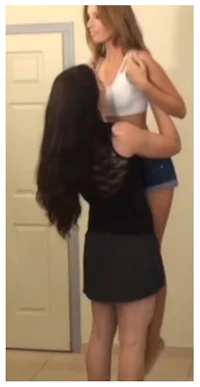 a woman is standing in front of a door with another woman