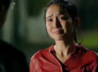 an asian woman is crying in the rain