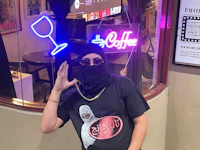 a man sitting on top of a car at night