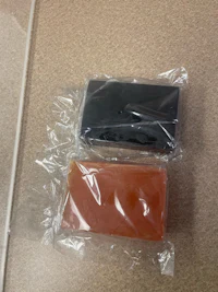 two pieces of soap in a plastic bag on a table