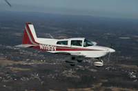 a small plane flying over a city