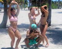 a group of people posing on a beach