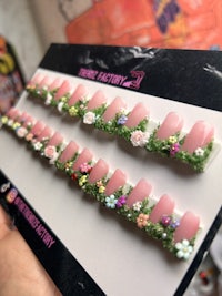 a package of pink nail art with flowers on it