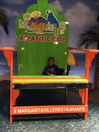 a boy sits in a booth at the atlantic city amusement park