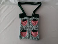 a crocheted bag with strawberries on it