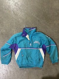 a blue and purple jacket on a concrete floor