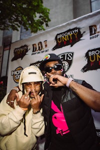 two men posing for a photo at an event