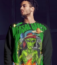 a man wearing a sweater with an alien on it