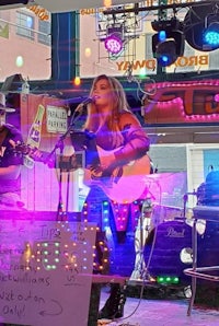 image may contain person, on stage, playing a musical instrument and indoor